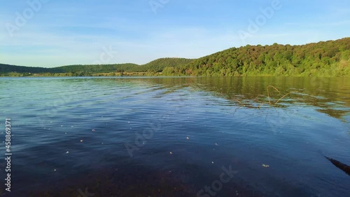 Panorama of the lake of Martignano. Hilly landscape, blue sky reflected in the water photo