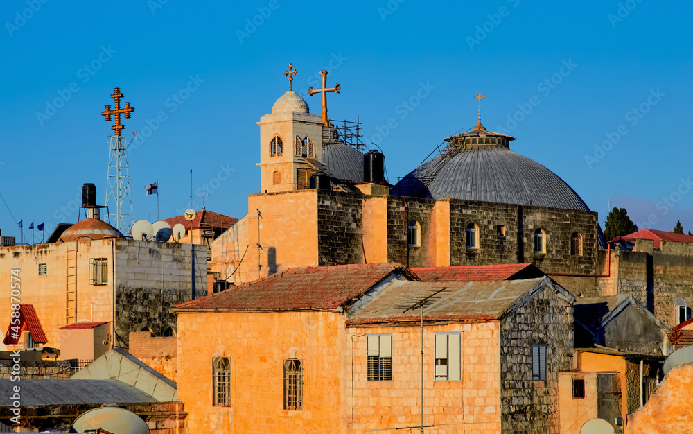 sunrise over Domes of the Church of the Holy Sepulcher and the ancient rooftops of the old city of jerusalem, israel