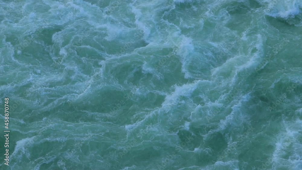 The surface of the water from a bird's eye view. Seething waves on a cloudy day. The surface of the water from a bird's eye view. Seething waves on a cloudy day.