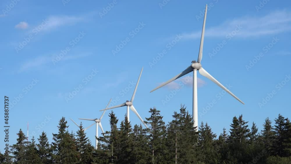 Langogne Wind Farm stick out of a pine tree forest - Wind Turbines Generating Renewable Energy Langogne Wind Farm stick out of a pine tree forest - Wind Turbines Generating Renewable Energy
