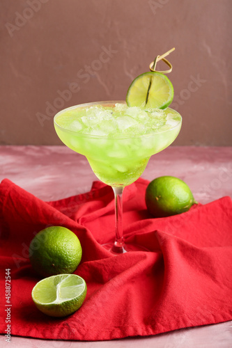 Glass with tasty daiquiri cocktail on color background photo