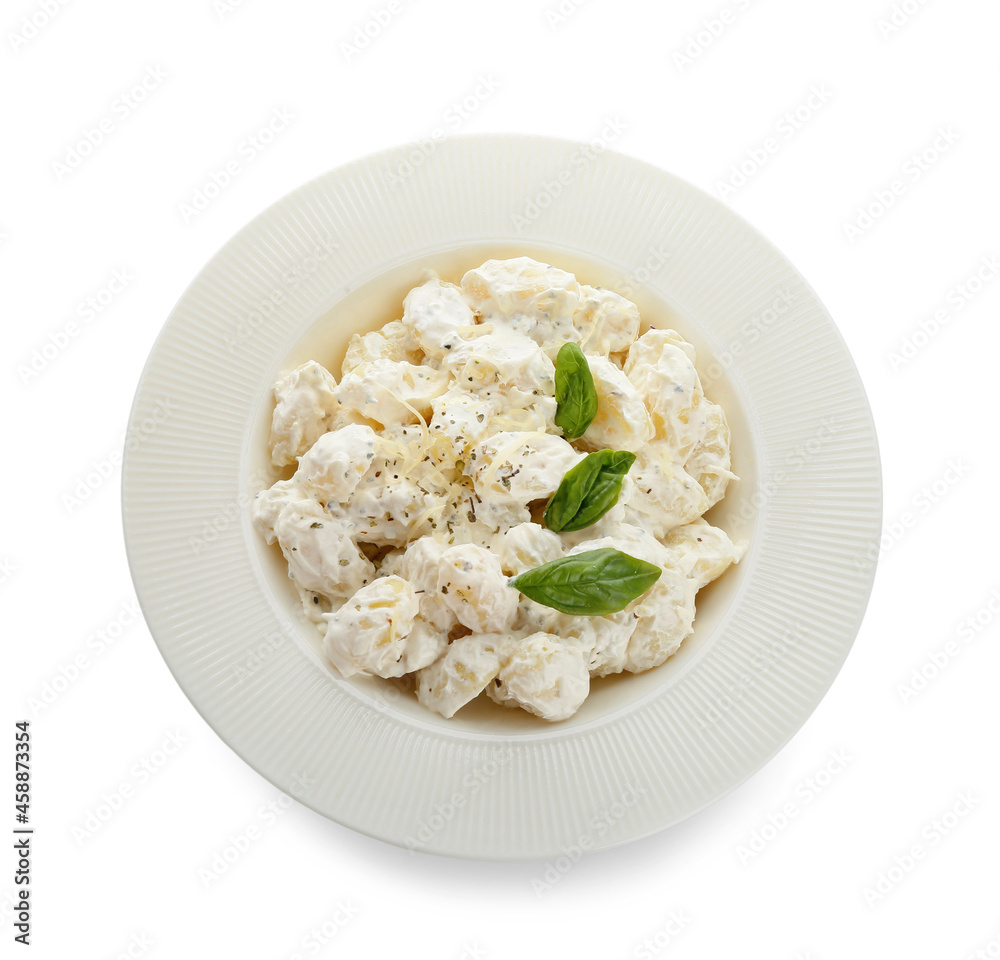 Plate of delicious gnocchi with creamy sauce on white background Plate of delicious gnocchi with creamy sauce on white background