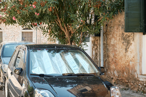 Sun protection on the windshield of a black car. Front view.