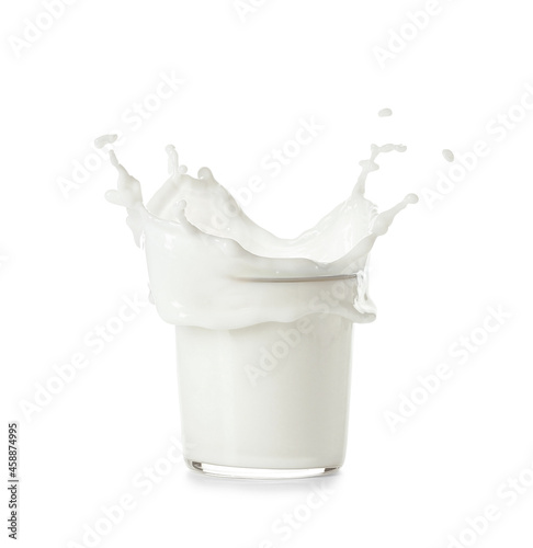 Glass of white milk splashing on white background