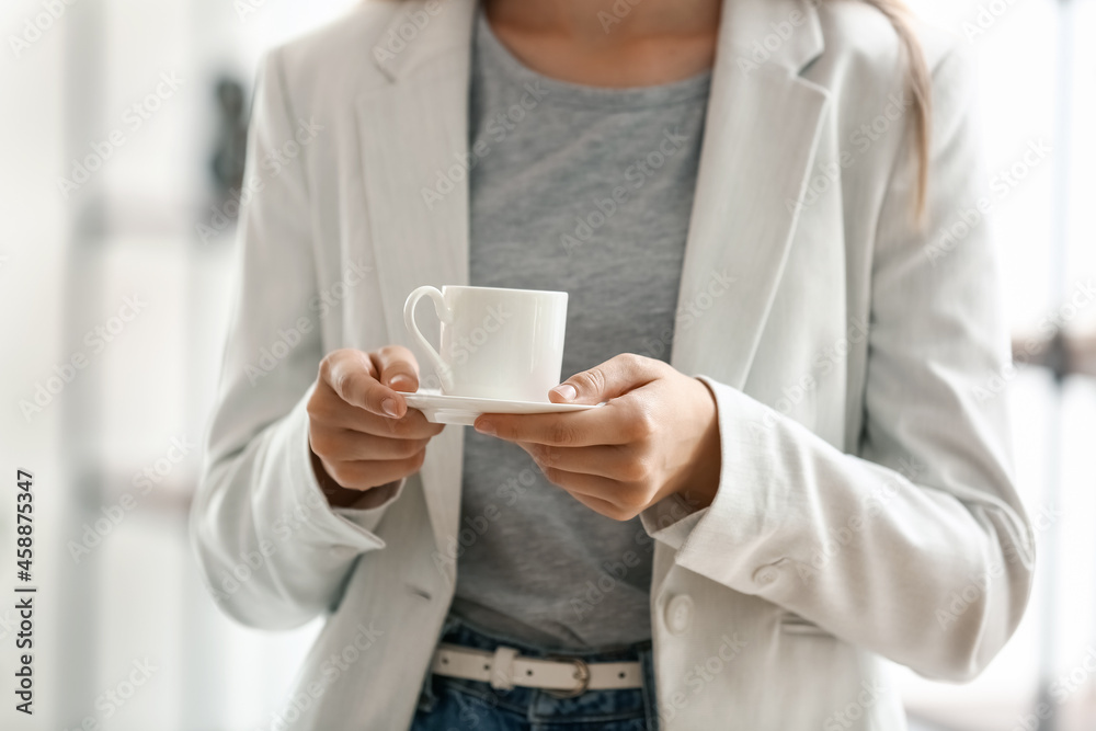 Young woman having coffee break in office, closeup Young woman having coffee break in office, closeup
