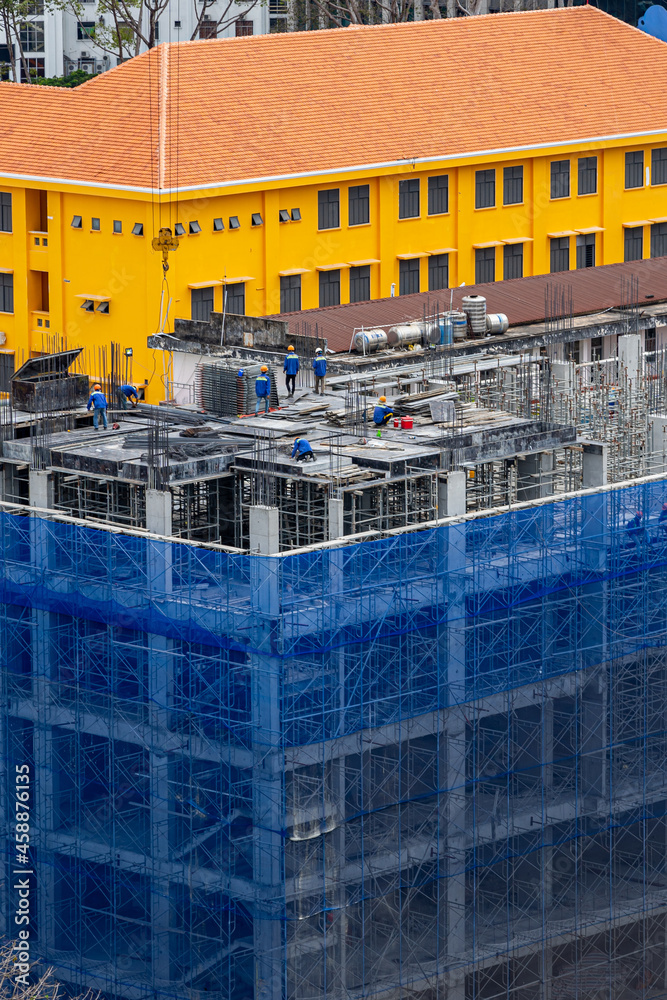 Vertical photo of new construction site with crane and mechanical ...