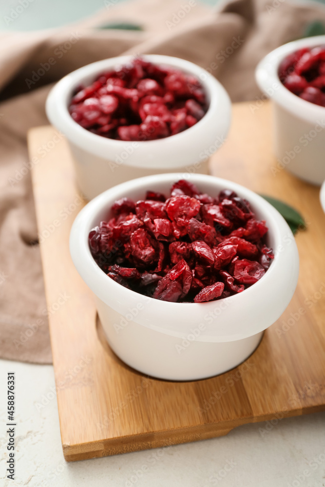 Bowls with tasty dried cranberries on table, closeup Bowls with tasty dried cranberries on table, closeup
