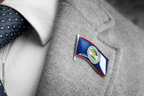 Metal badge with the flag of Belize on a suit lapel photo