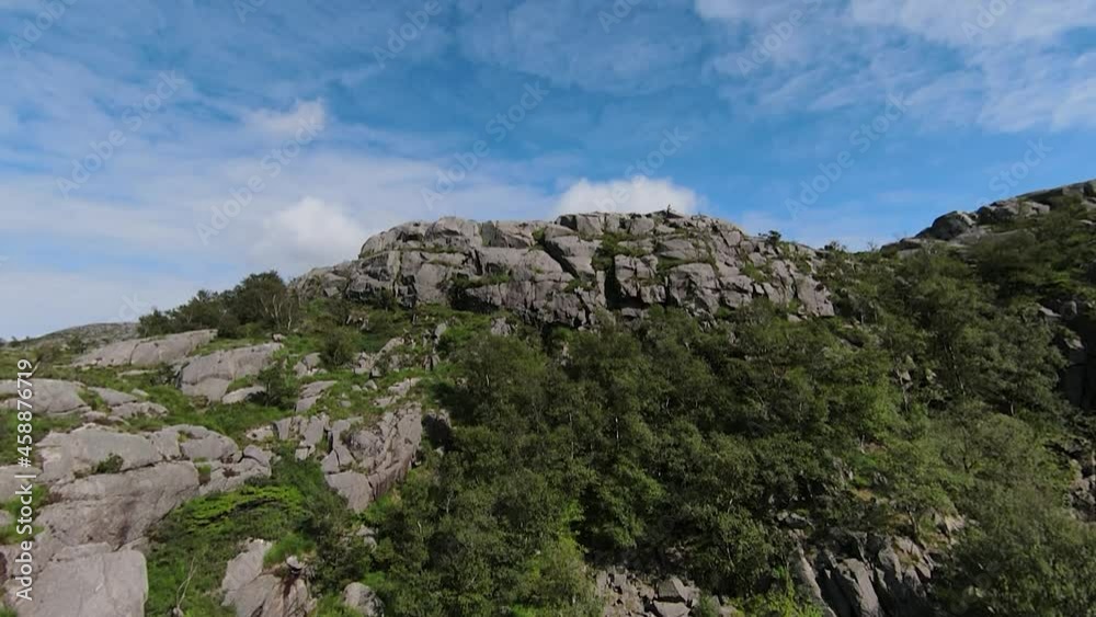 Drone flight over a rugged terrain into a valley Drone flight over a rugged terrain into a valley