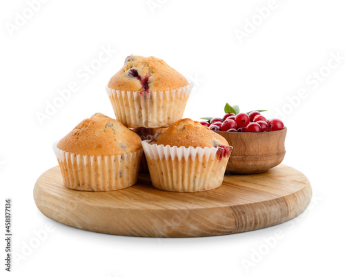 Wooden board with tasty cranberry muffins on white background