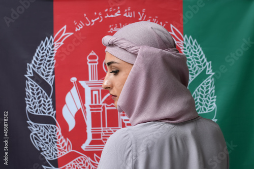 Muslim woman against flag of Afghanistan