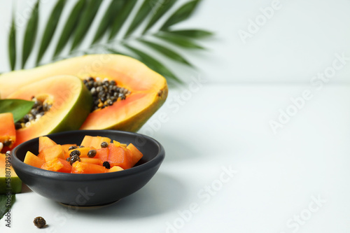Fresh ripe papaya on white table, space for text