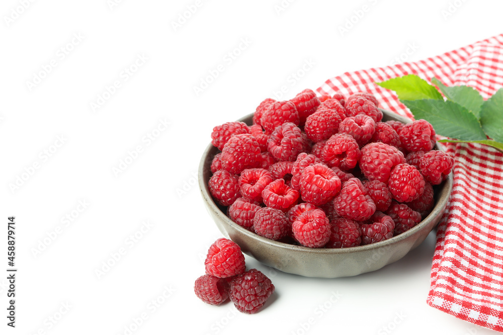 Red juicy raspberries in bowl and kitchen towel, isolated on white background Red juicy raspberries in bowl and kitchen towel, isolated on white background