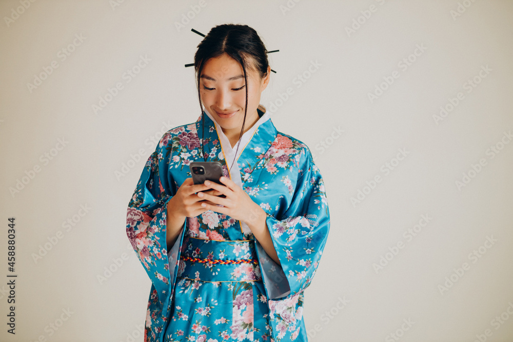 Japanese woman in traditional kimono in studio