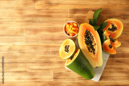 Fresh ripe papaya on light wooden table photo