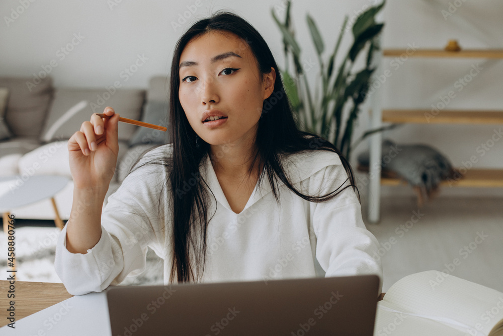 Woman working on computer at the desk from home Woman working on computer at the desk from home