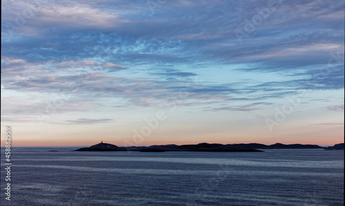 Low lying Islands silhouetted in the Early Morning Light on the Norwegian West Coast near to Bergen, on a calm Morning. photo