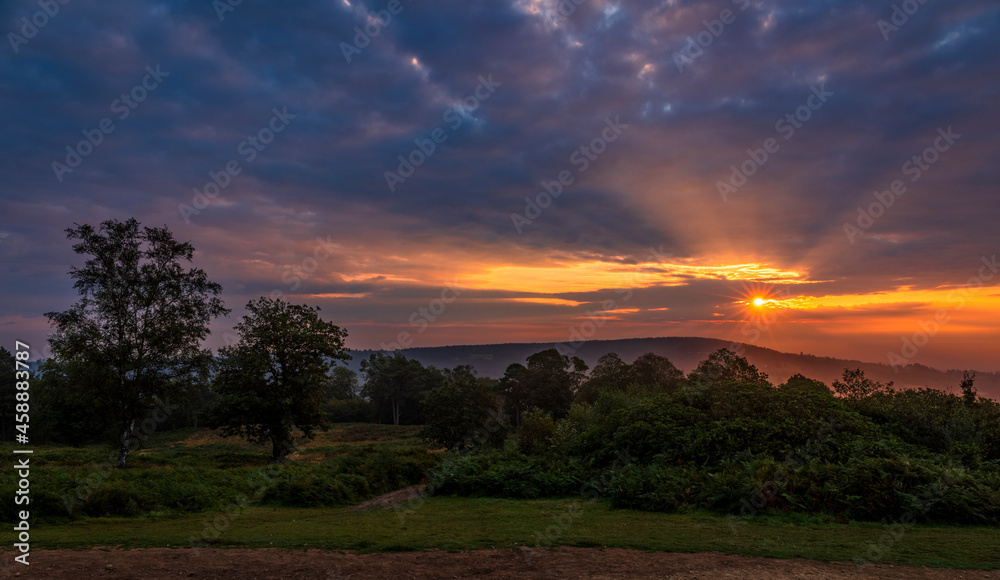 Dramatic September sunrise behind Leith hill from Holmbury Hill on the Surrey Hills, south east England