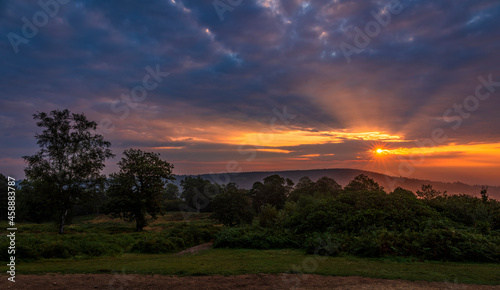 Dramatic September sunrise behind Leith hill from Holmbury Hill on the Surrey Hills, south east England © SuxxesPhoto