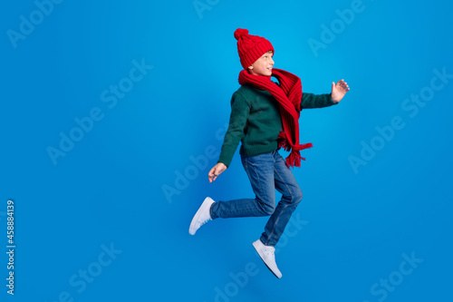 Full length body size photo boy jumping up looking copyspace isolated bright blue color background