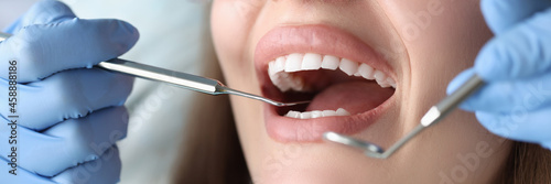Dentist conducts medical examination of patient teeth