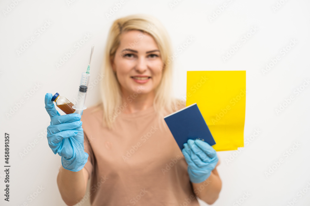Portrait smart confident Caucasian female traveler holding virus, showing syringe and passport with vaccinated immune certification Portrait smart confident Caucasian female traveler holding virus, showing syringe and passport with vaccinated immune certification