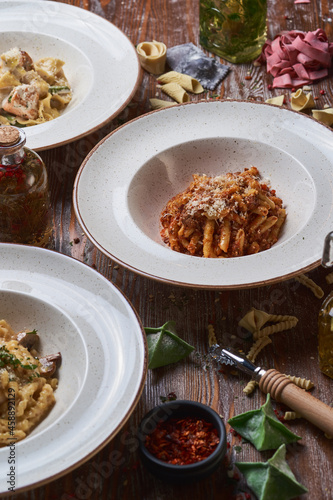 three types of Italian pasta on a wooden table