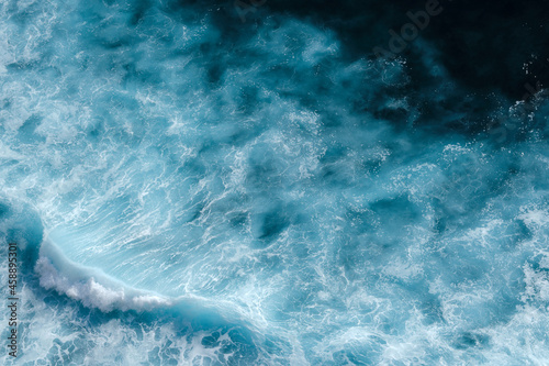 Aerial view to seething waves with foam. Waves of the sea meet each other during high tide and low tide