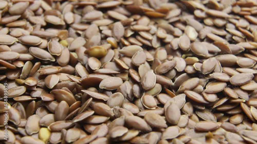 Flax seeds pouring end rotating in slow motion Flax seeds pouring end rotating in slow motion