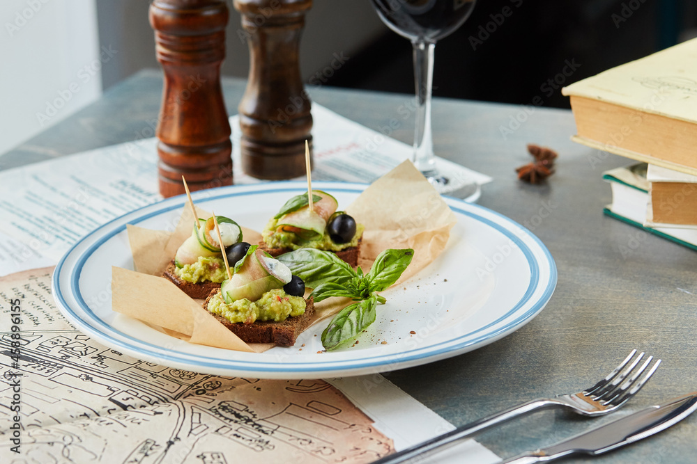 bruschetta on a wooden table in a white plate