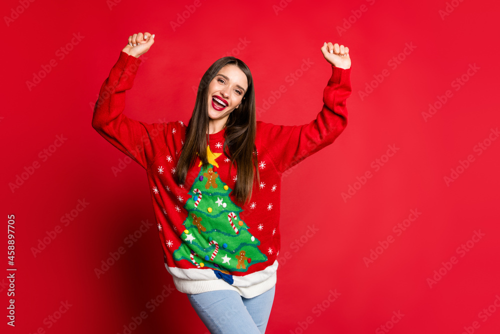 Photo of happy cheerful victorious young woman raise hands good mood win isolated on red color background Photo of happy cheerful victorious young woman raise hands good mood win isolated on red color background