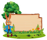 Empty wooden board with a rabbit in the garden isolated
