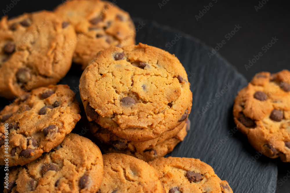 Fresh crispy chocolate cookies on a dark table Fresh crispy chocolate cookies on a dark table