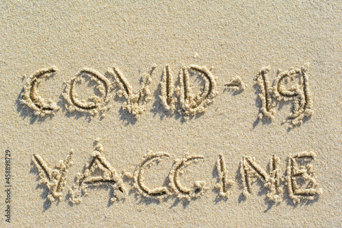 Writing COVID-19 VACCINE word on sand at Samui island the famous place in Thailand on summer with copy space