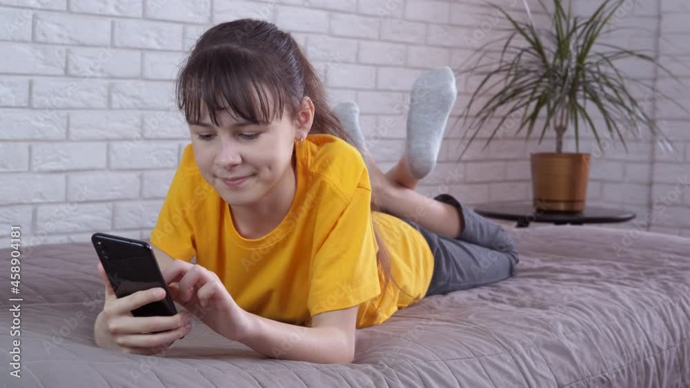 Girl on social networks. Happy teenage girl on the couch with a smartphone. Girl on social networks. Happy teenage girl on the couch with a smartphone.