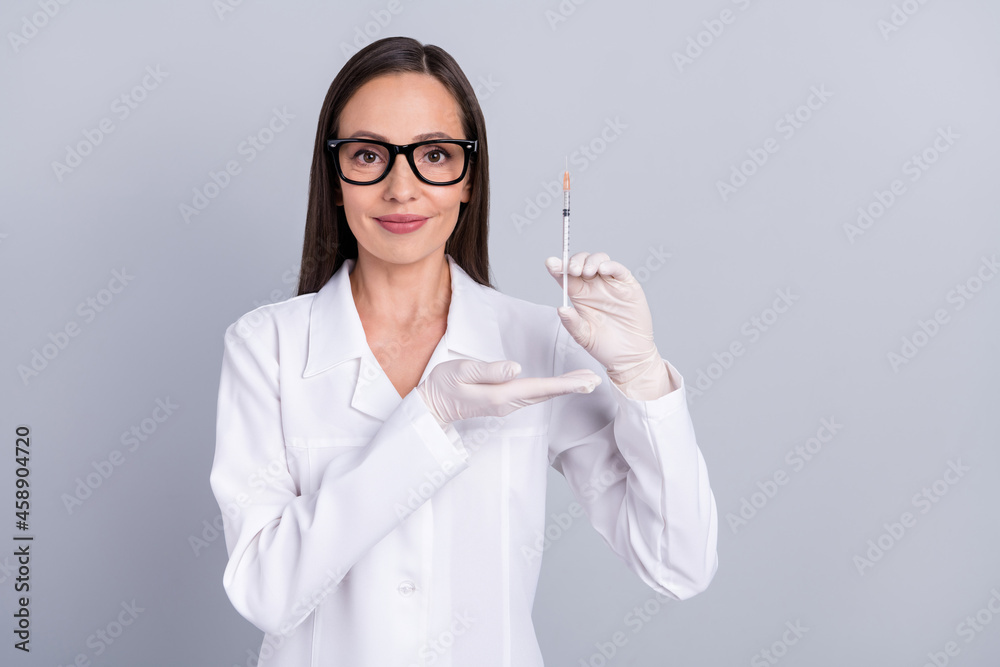 Photo of mature woman happy positive smile show ad advise injection vaccination isolated over grey color background