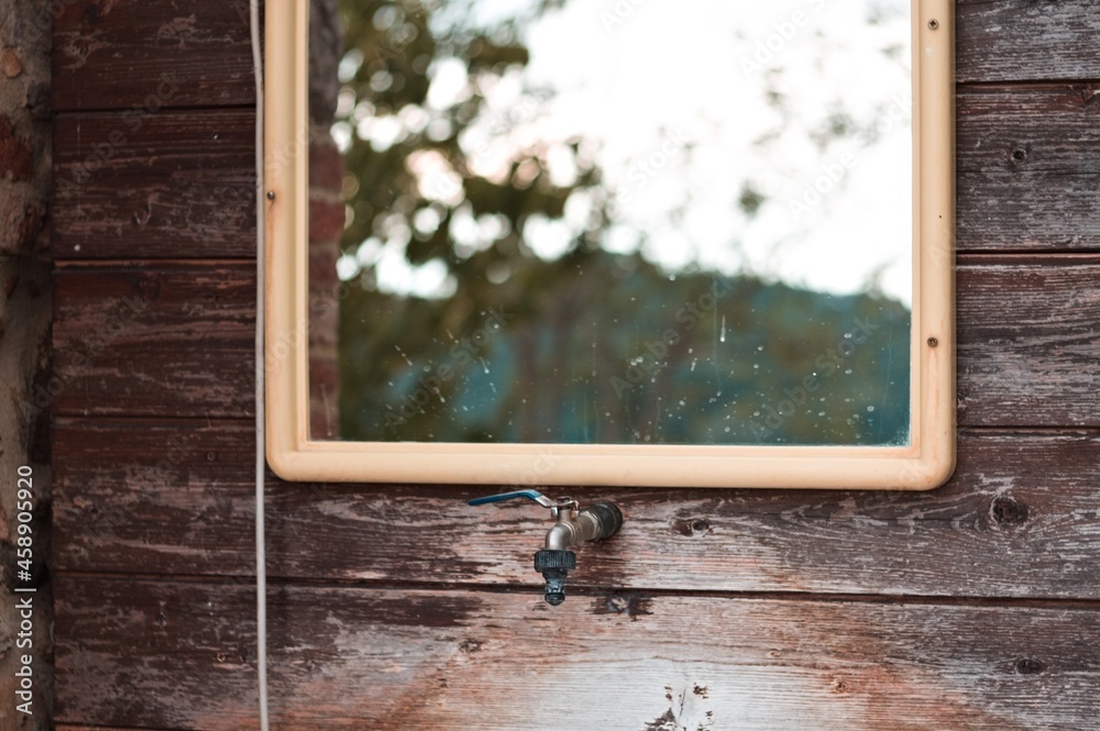 An external sink under a mirror in the garden of a farmhouse in the countryside (Umbria, Italy, Europe)