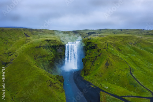 Aerial drone view of Skogafoss waterfall in Iceland, one of the most famous tourist visited attraction and landmark