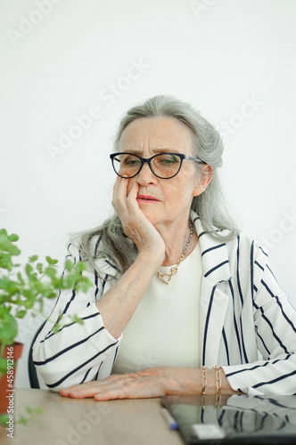 Closeup portrait of angry upset senior mature businesswoman at the office. Negative emotion, facial expression photo