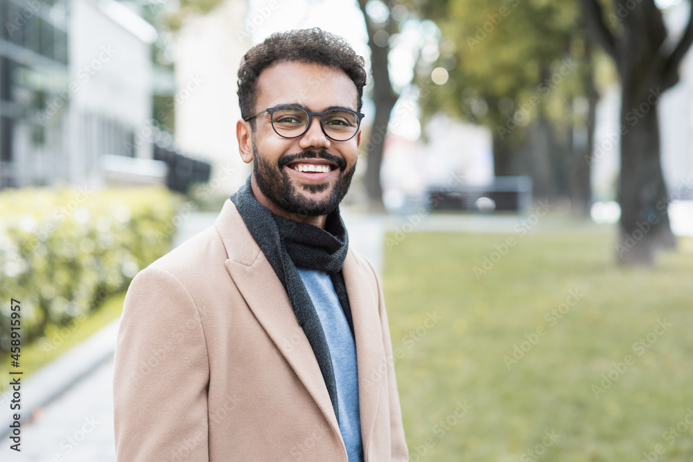 Handsome smiling business man autumn portrait. Joyful men student wearing warm clothes in a city in winter Handsome smiling business man autumn portrait. Joyful men student wearing warm clothes in a city in winter
