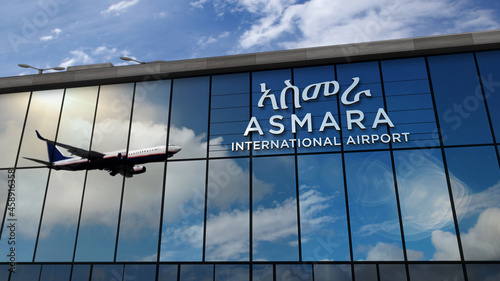 Airplane landing at Asmara Eritrea airport mirrored in terminal photo