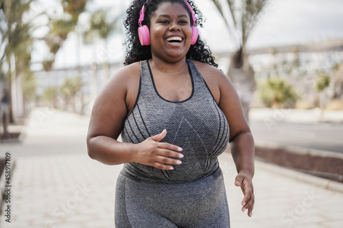 Canvastavla Curvy african woman jogging outdoor at city park - Sport concept - Focus on face