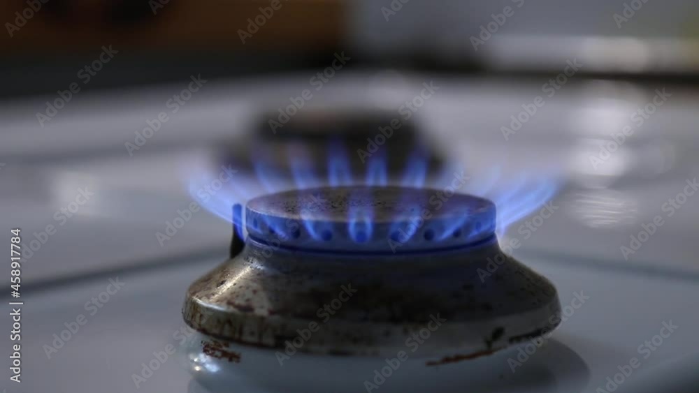 Blue Flame on a kitchen Gas Stove, turning gas up creating a bigger