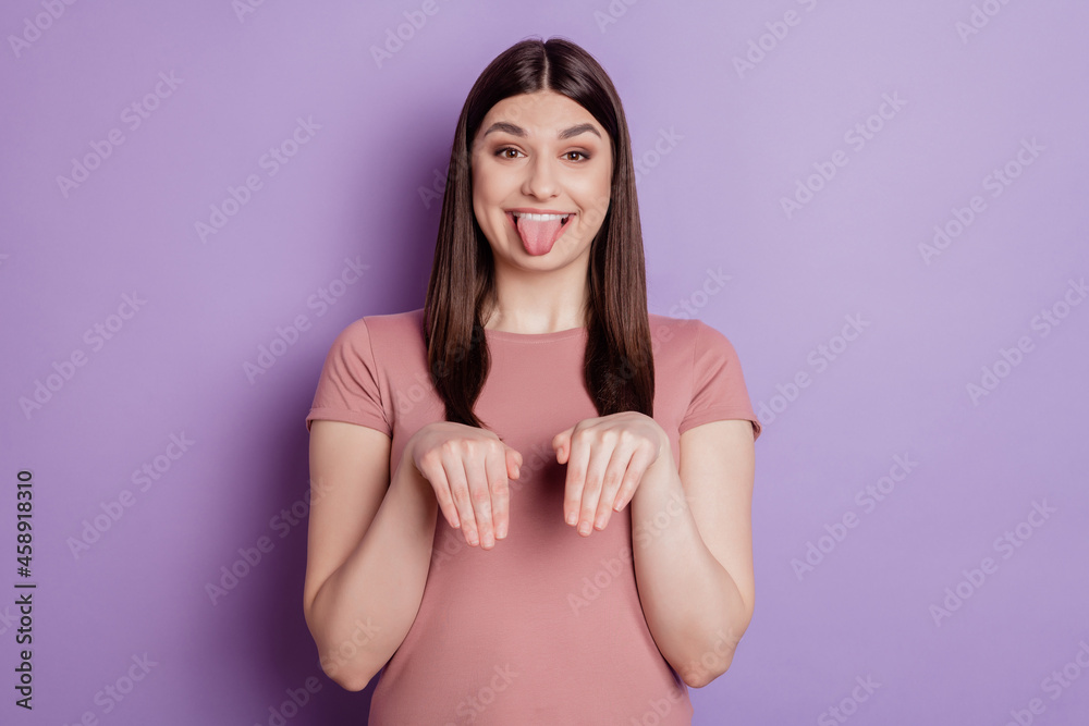 Portrait of charming funny foolish lady hands paws pretending dog showing tongue on purple background Portrait of charming funny foolish lady hands paws pretending dog showing tongue on purple background
