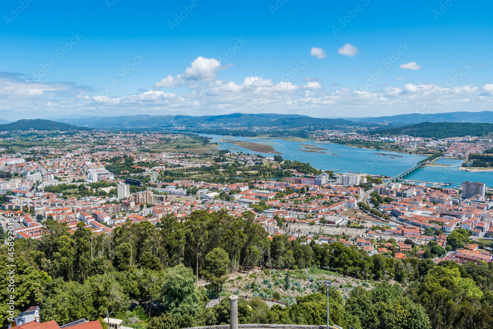 Trees and construction of the city of Viana do Castelo with two bridges over the river Lima and mountains in the background, PORTUGAL