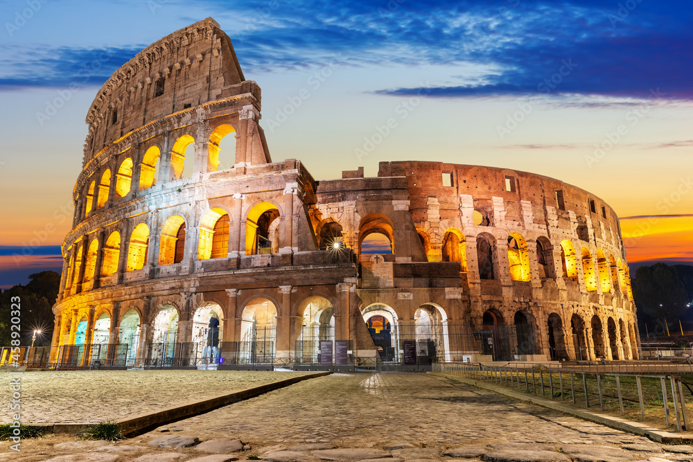 The Colosseum illuminated at sunrise, front view, Rome, Italy