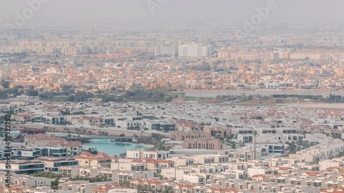 Aerial view of many apartment houses in Dubai city from above timelapse photo