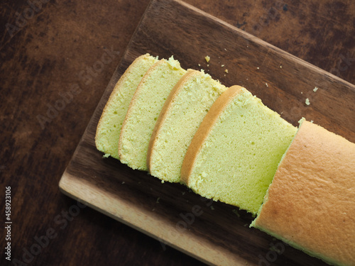 Sliced pandan chiffon cake on wooden board