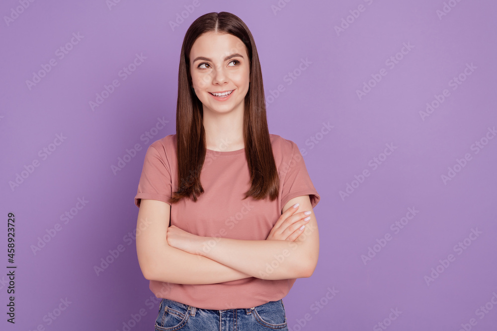 Photo of attractive lady crossed hands look empty space isolated on violet background Photo of attractive lady crossed hands look empty space isolated on violet background