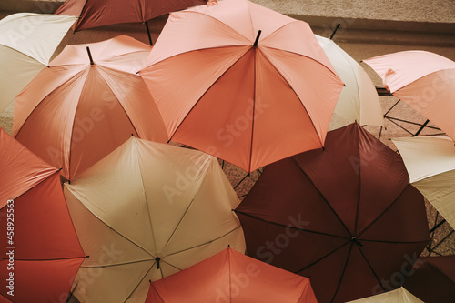 A lot uf red, yellow and orange umbrellas. Autumn colors.